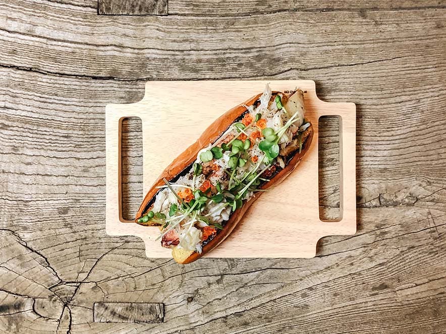 lobster roll aerial shot on wooden cutting board