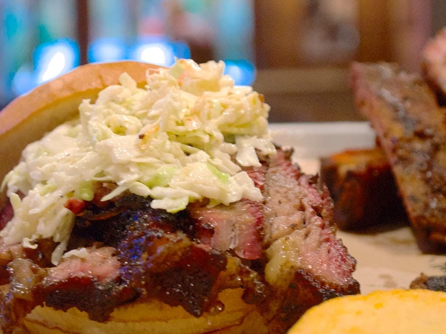 A brisket sandwich served with coleslaw