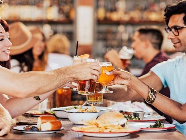 Picture of friends toasting glasses outdoors at outdoor bar