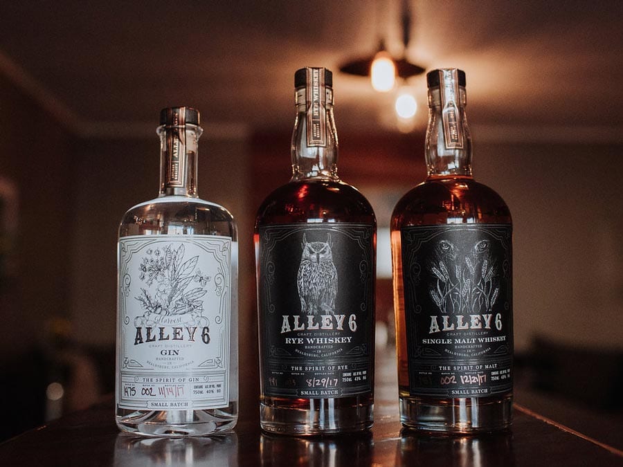 Three bottles of spirits lined up on a table