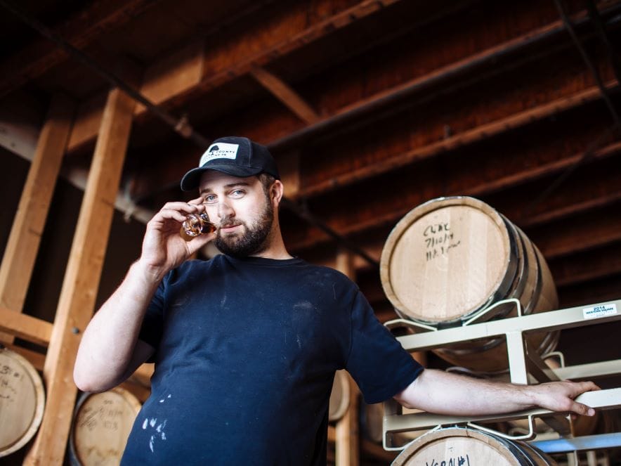 Picture of distiller at Sonoma County Distilling sniffing small glass of whiskey