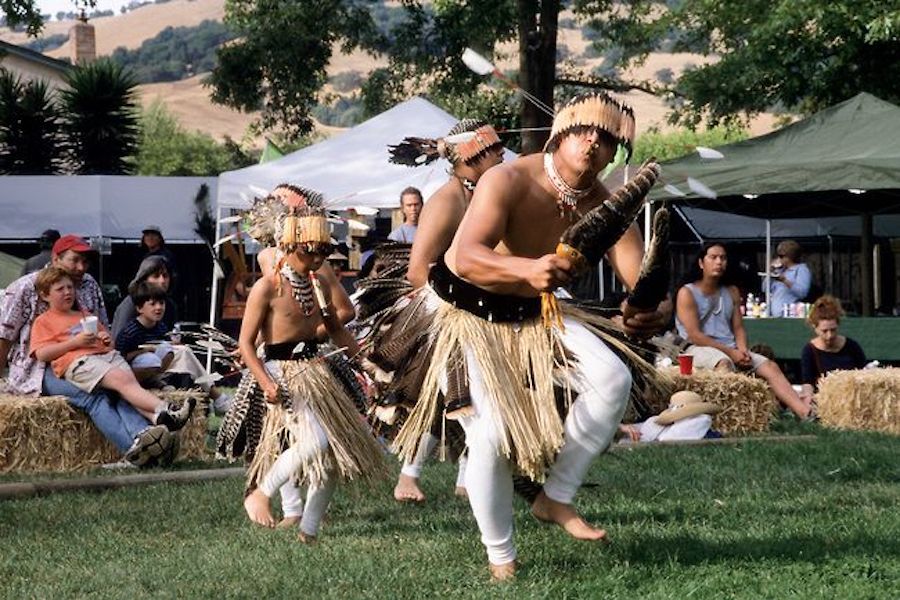 Tribal members of the Dry Creek Rancheria dancing in traditional Pomo Regalia