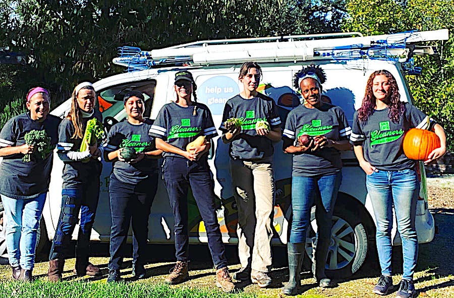 Duskie Estes and some of her Farm to Pantry gleaners beside their company van 