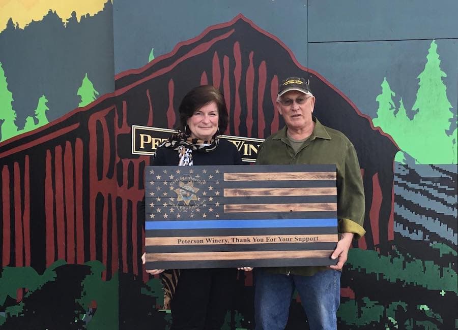 Fred Peterson at his Dry Creek Valley tasting room, holding an award from the CHP Memorial Wall Fund, for which he helped raise thousands of dollars 