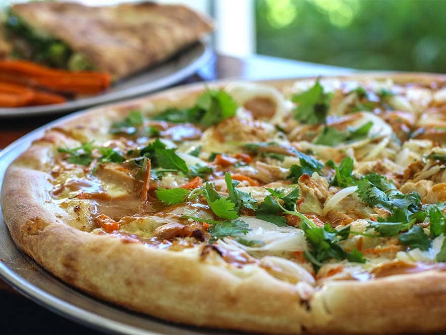 thai pizza with peanut sauce and cilantro