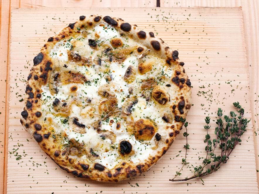 white pizza on wooden cutting board