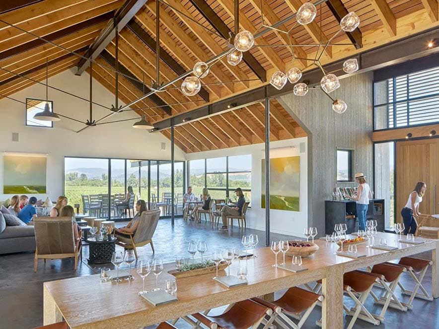 tasting room with windows looking out at vineyards