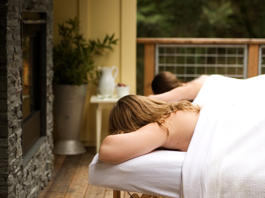 A woman lies on a massage table