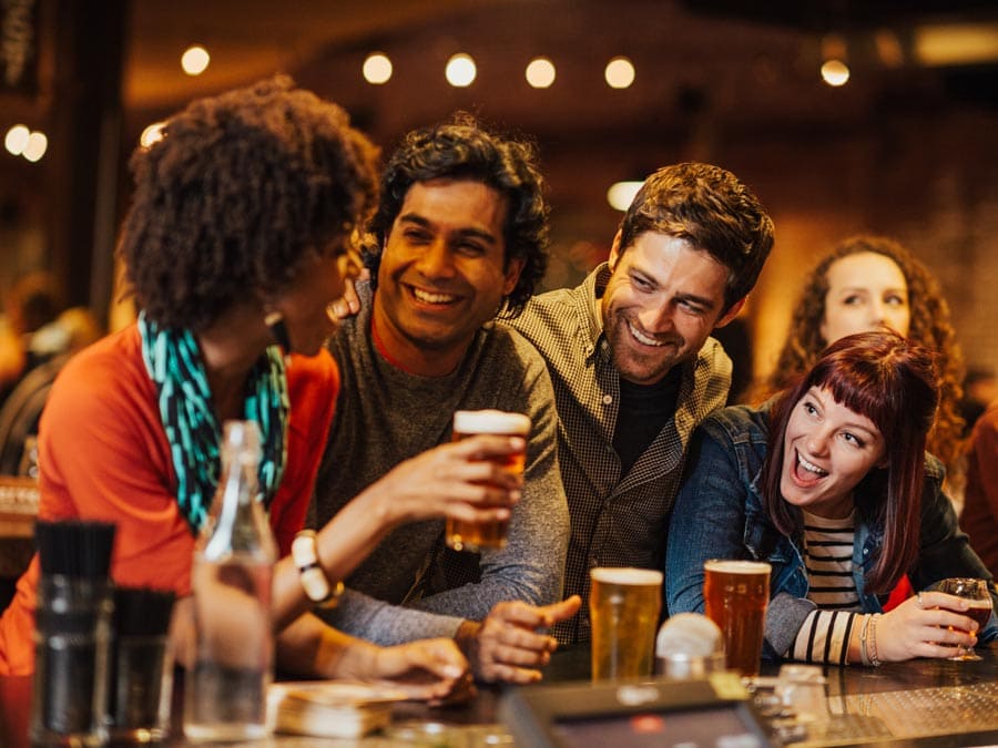 A group of friends enjoys drinks at the bar at Brewsters Beer Garden, Petaluma