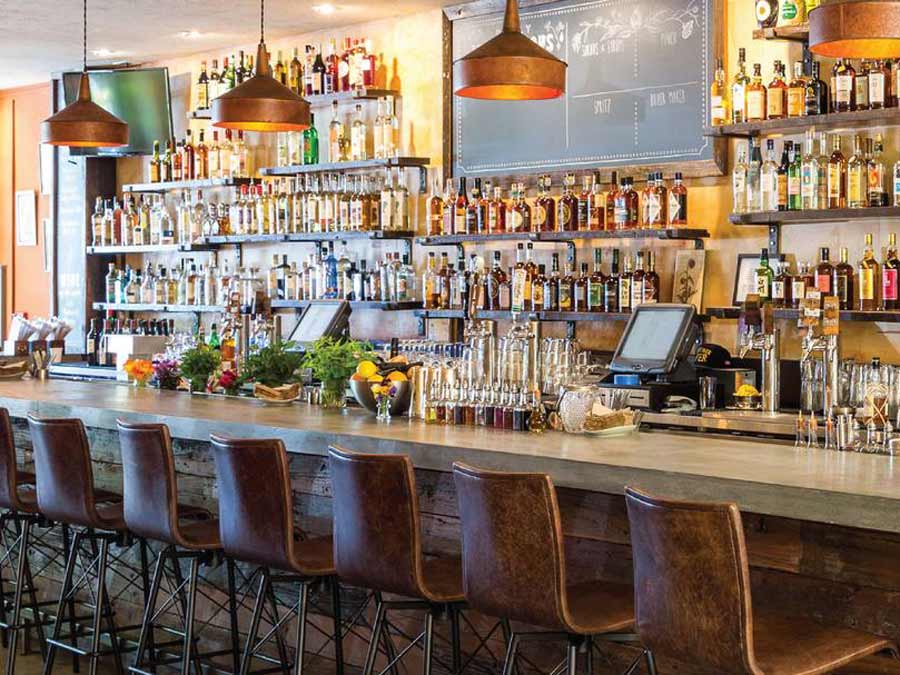 A wall of liquor bottles frames the bar at Duke's Spirited Cocktails, Sonoma County