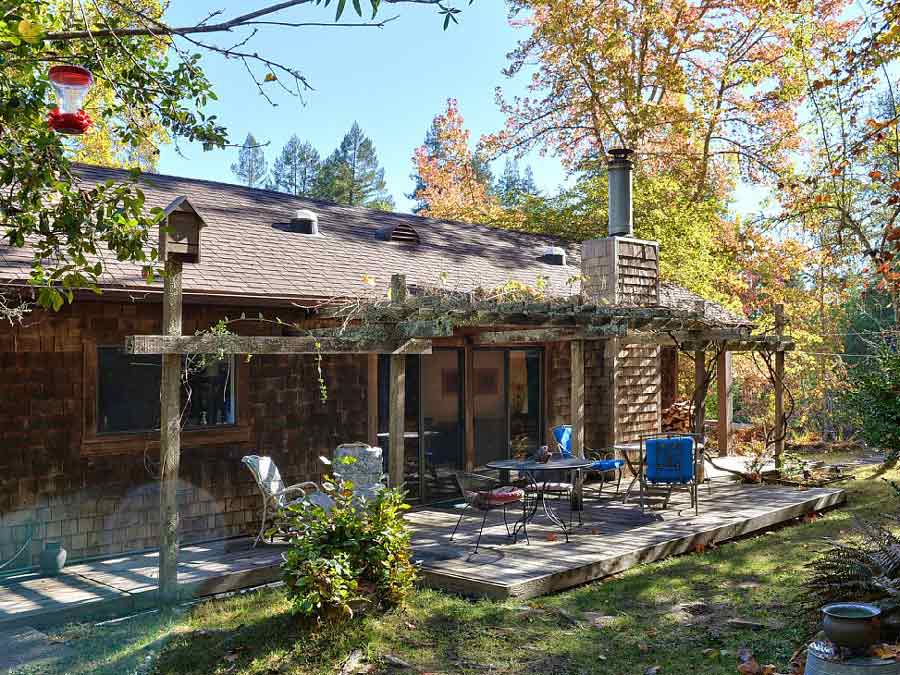 A rustic cottage surrounded by trees