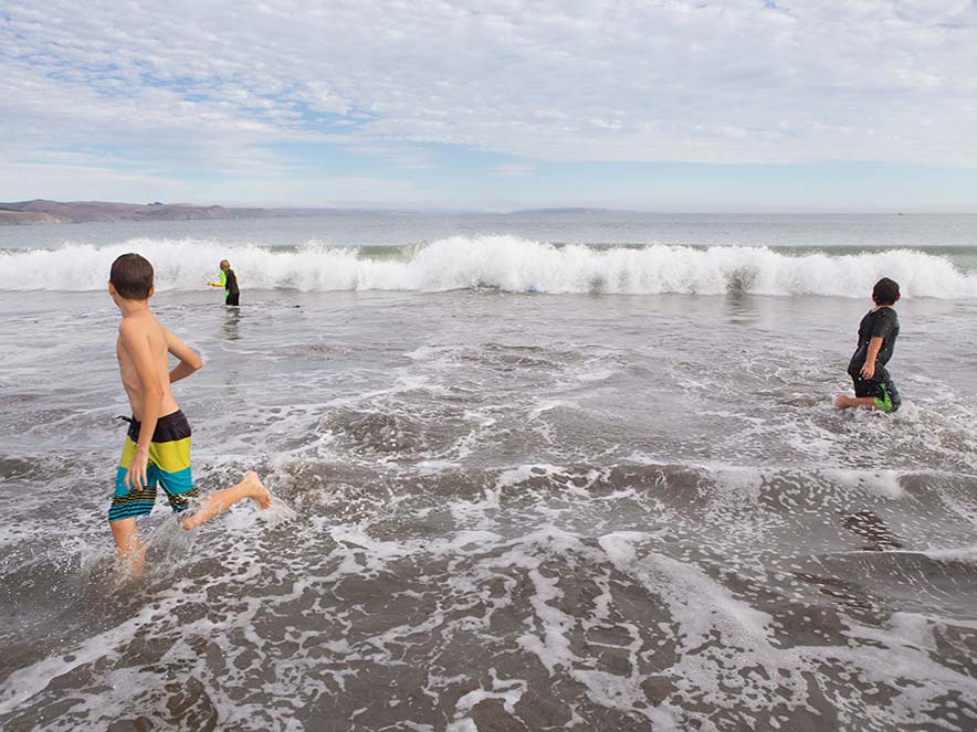 kids playing in the coast in sonoma county