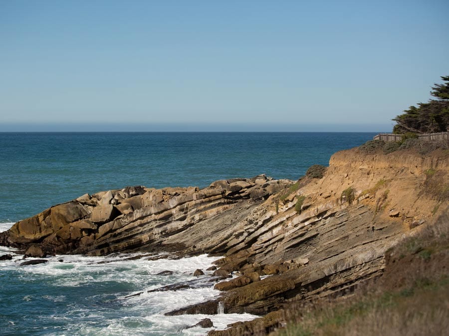 The rugged coastline is where the waves crash along the shore