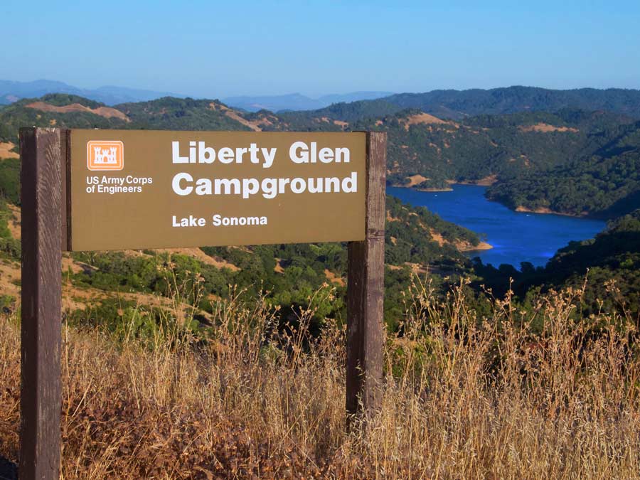 A sign for Liberty Glen Campground at Lake Sonoma sits above the lake in Sonoma County