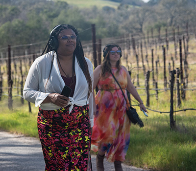 Two women walking in a vineyard