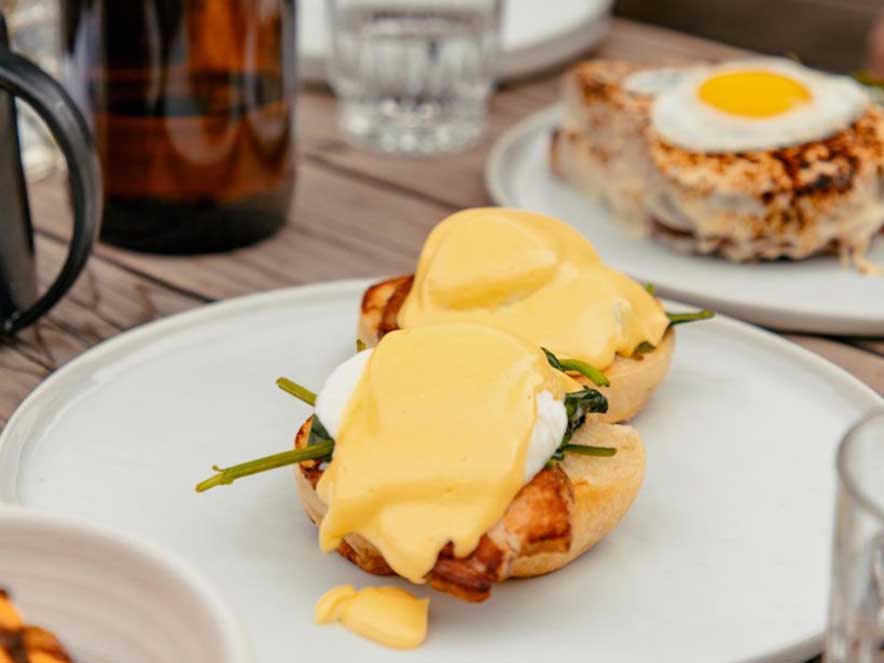 eggs benedict and other brunch dishes on table