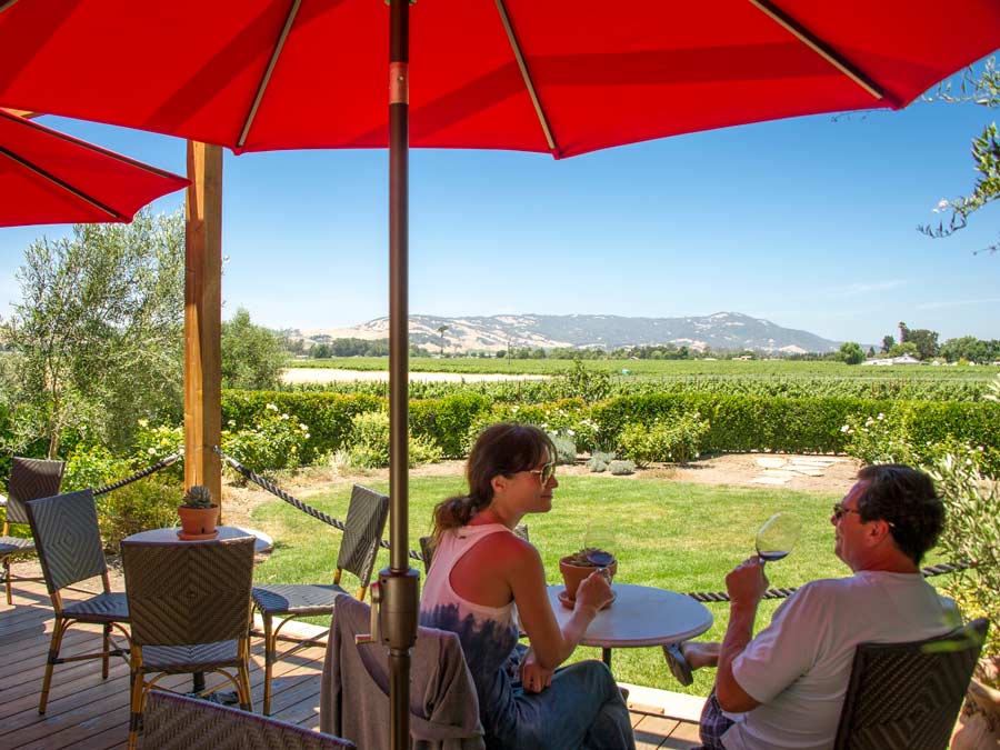 A couple tastes wine on the deck overlooking Carneros AVA at Anaba Wines, Sonoma County