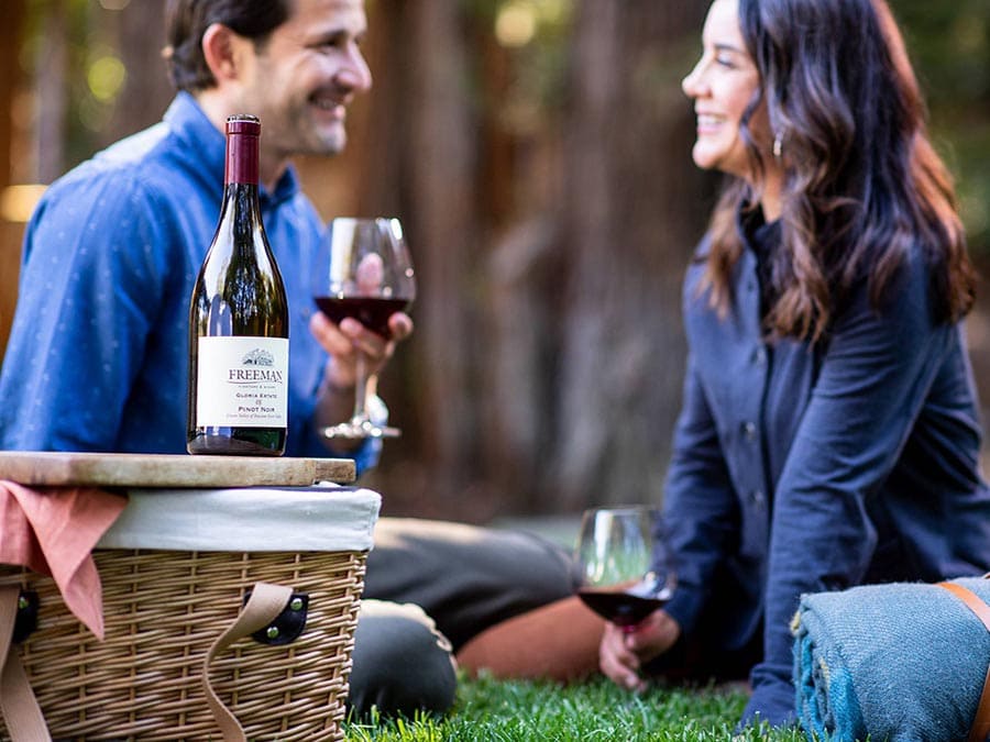 man and woman drinking wine on lawn