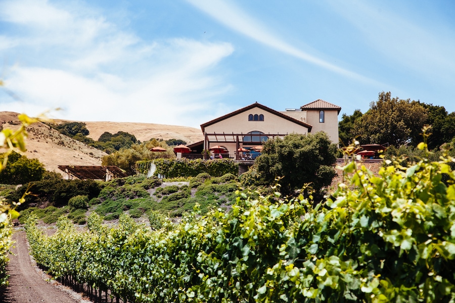 Vineyard-surrounded exterior of the Spanish-style Gloria Ferrer Caves & Vineyards 