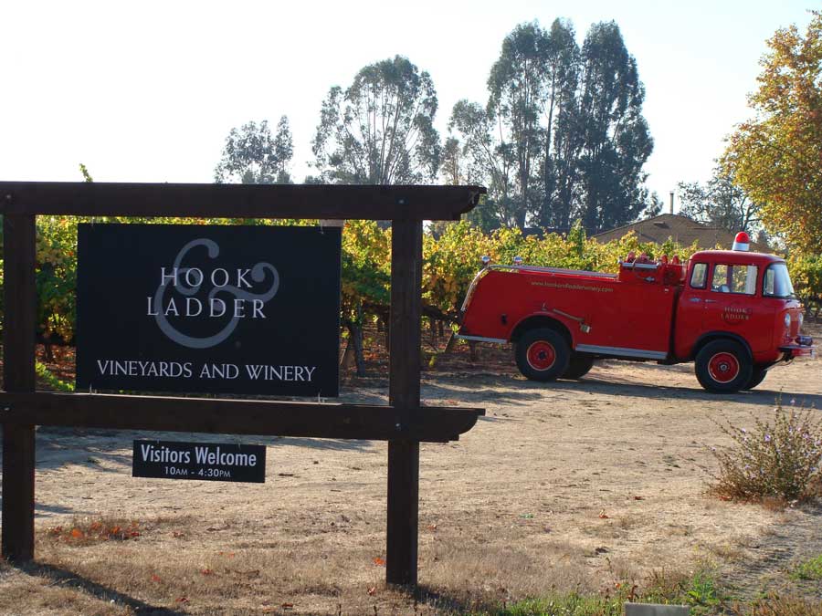 An old-fashioned fire truck sits outside of the winery next to the vineyards in Sonoma County