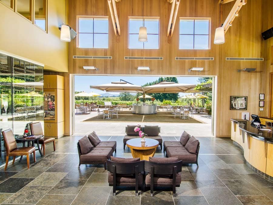 The interior of the modern tasting room has comfy couches