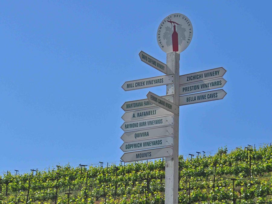 A sign post with the names of many wineries in Dry Creek Valley, AVA