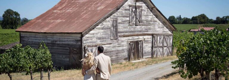 Bride and groom by barn venue in Sonoma County