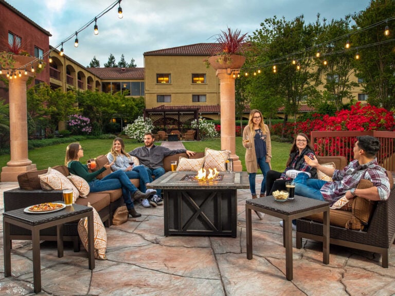 group of people around a fireplace at their hotel in Sonoma county