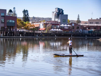 visitor paddle boarding the petaluma river in sonoma county