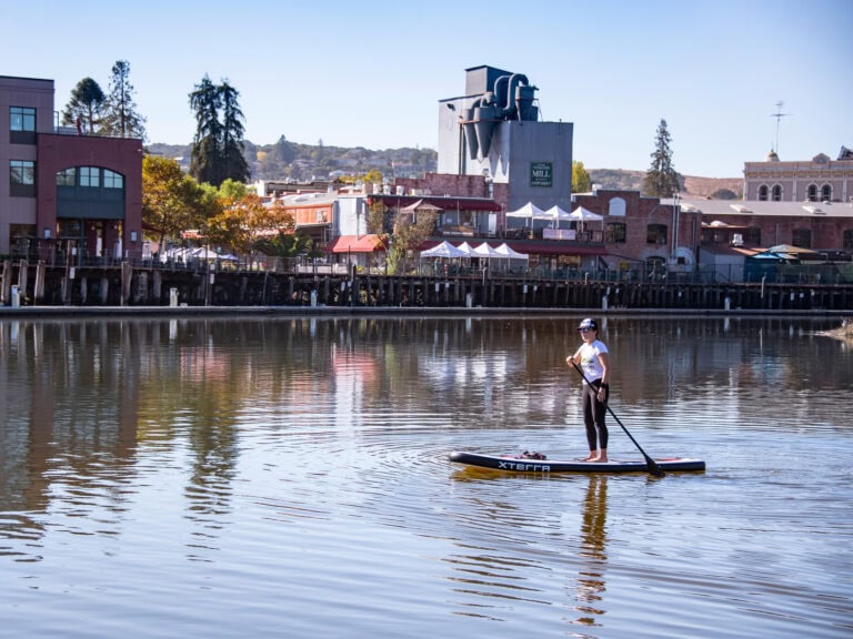 visitor paddle boarding the petaluma river in sonoma county