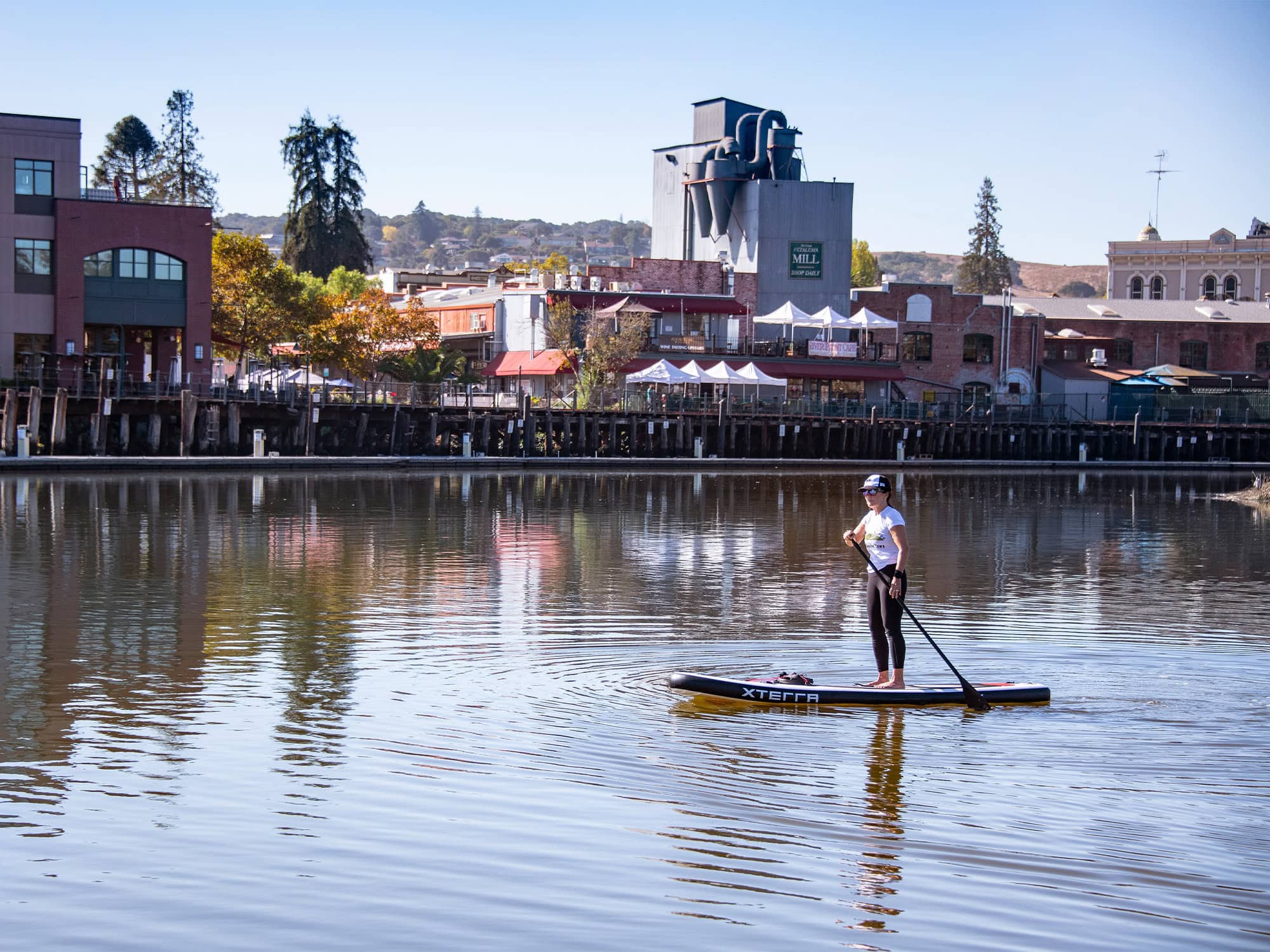 visitor paddle boarding the petaluma river in sonoma county