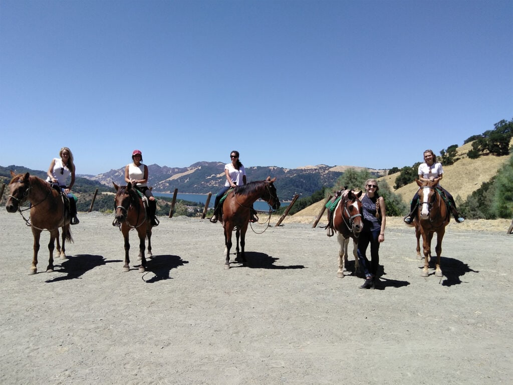 a bridal party horseback riding at lake sonoma in sonoma county