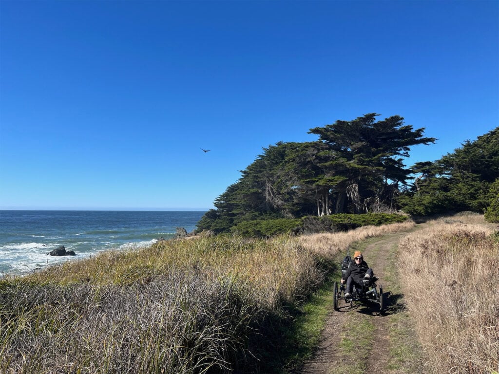 visitor in a wheelchair walking a trail in the sea ranch sonoma county coast line