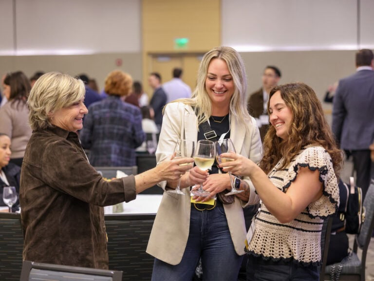 group of people enjoying a glass of wine at sonoma county tourism annual meeting happy hour