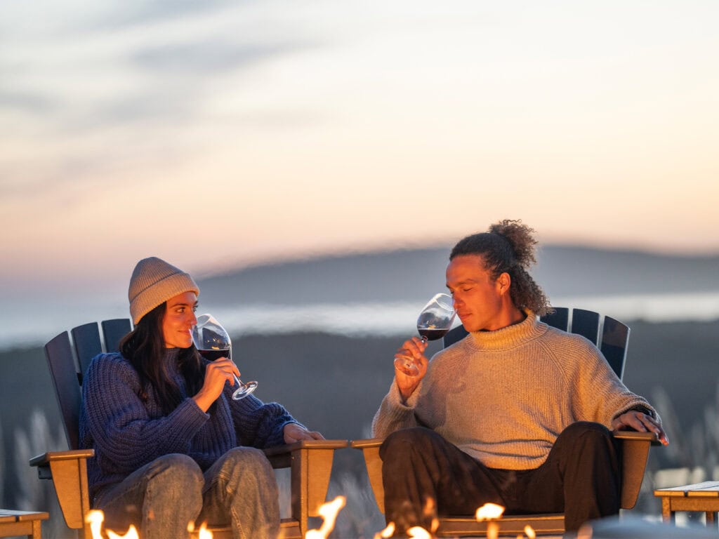 couple enjoying a glass of wine by the firepit at the lodge at bodega bay at the sonoma coast