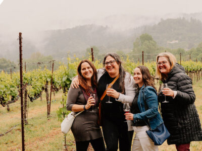 group of girls drinking wine in the vineyard at passport wine festival in sonoma county