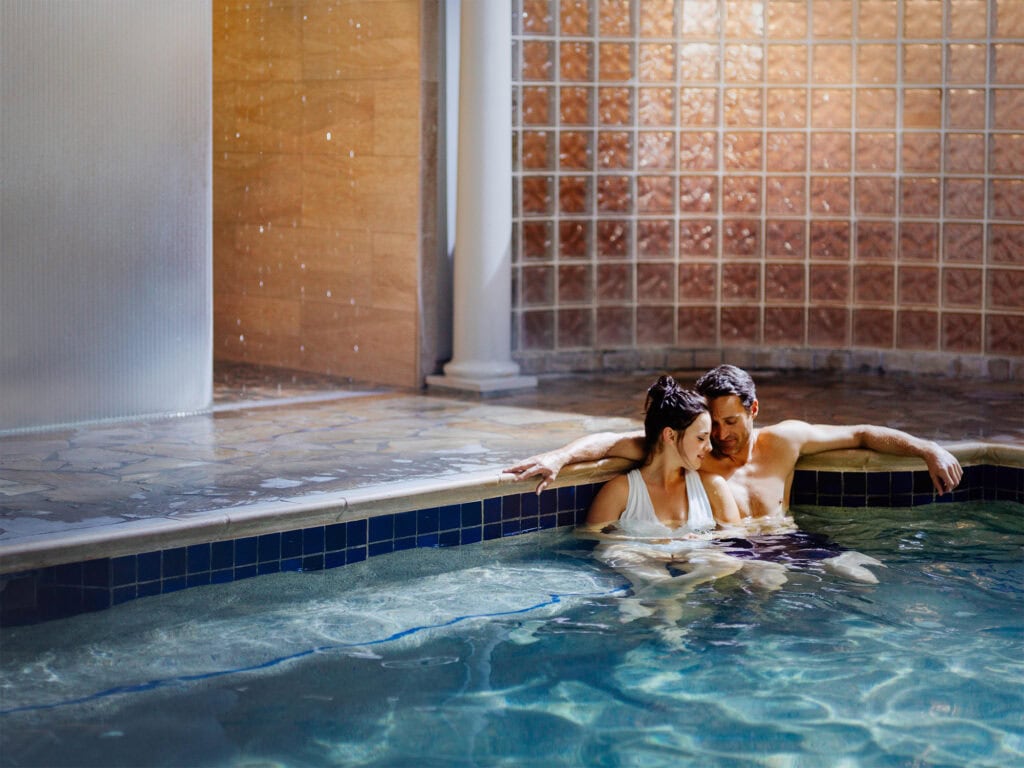 a couple enjoying the geothermal mineral pool at the fairmont spa in sonoma county