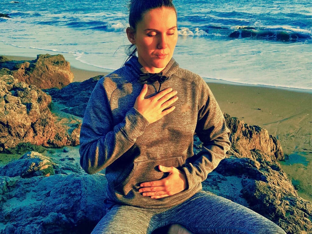 person practicing reiki during a self care trip on the sonoma coast  