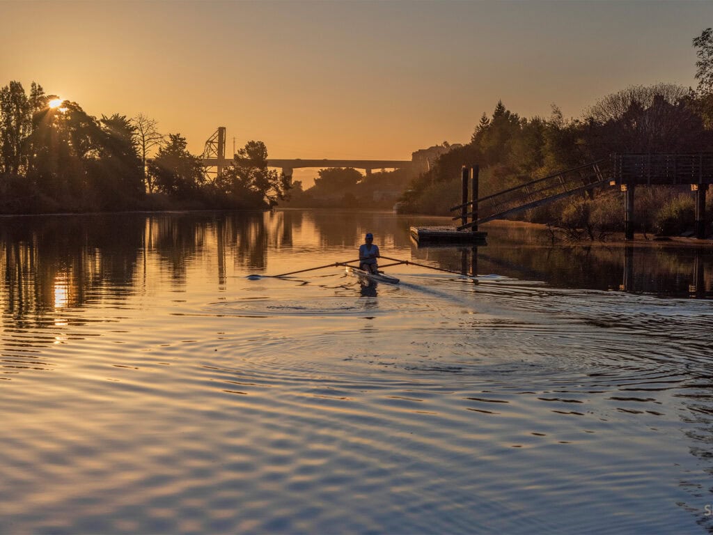 person paddling the petaluma river during a moon paddle event at the floathouse in sonoma county