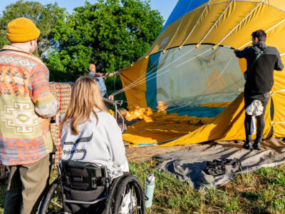 couple watching the hot air balloon fill up before they go on their wheelchair friendly hot air balloon ride