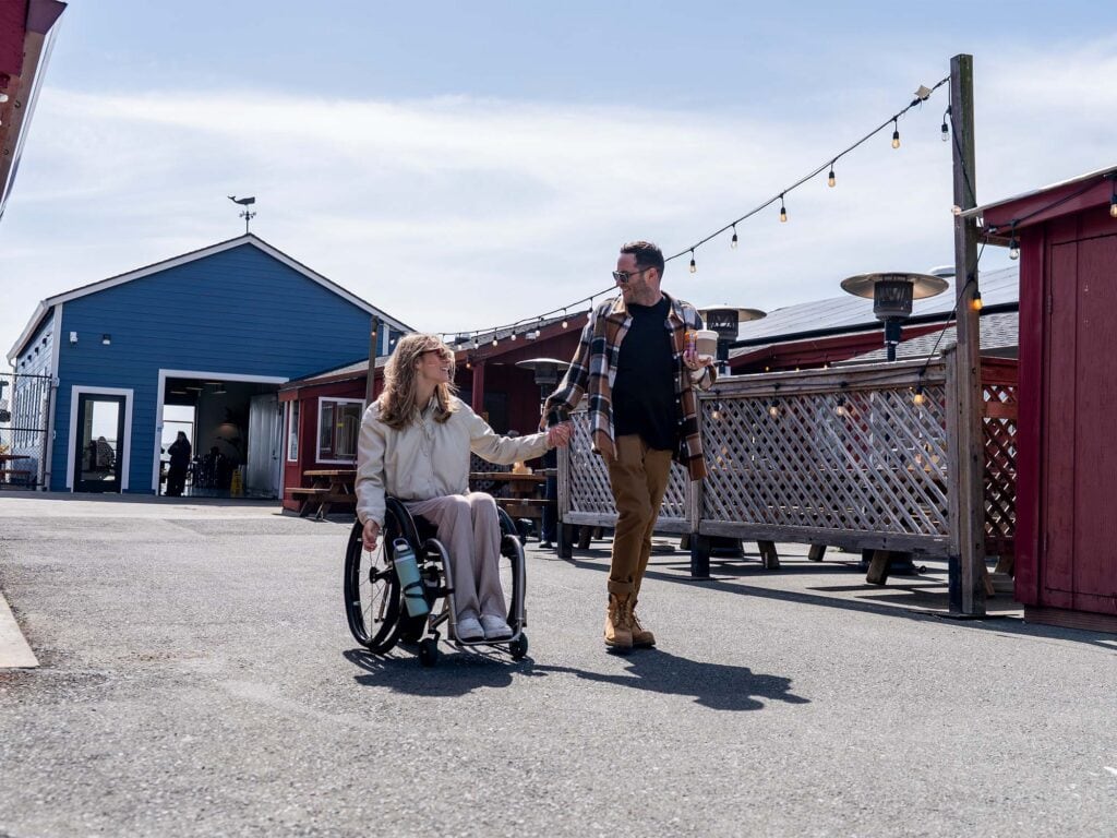 a wheelchair user rolling down the easy path at the fishatarian restaurant in sonoma county
