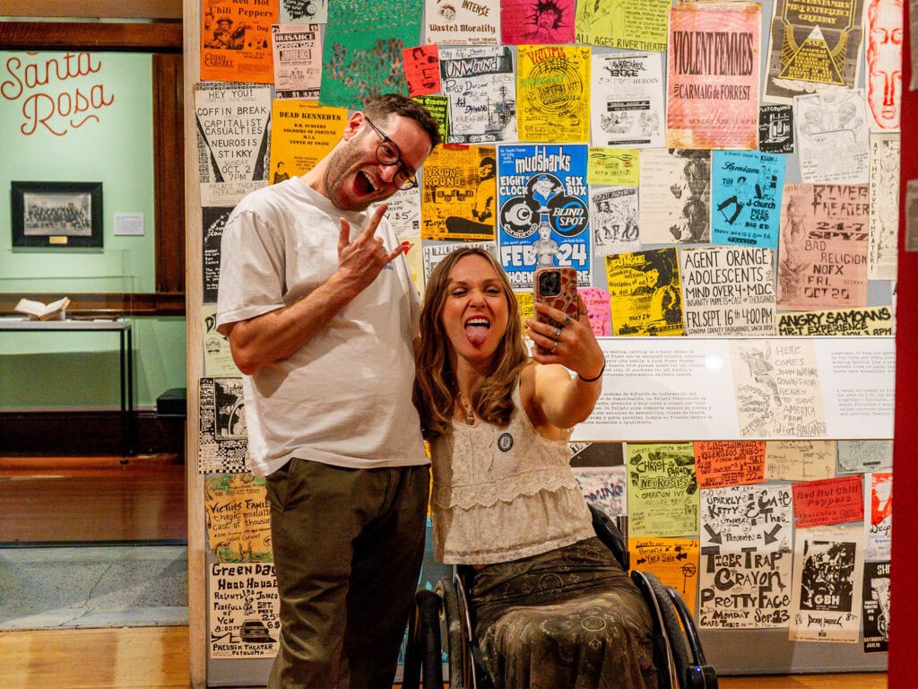 wheelchair user and her partner experiencing the punk rock exhibit at th sonoma county museum in santa rosa