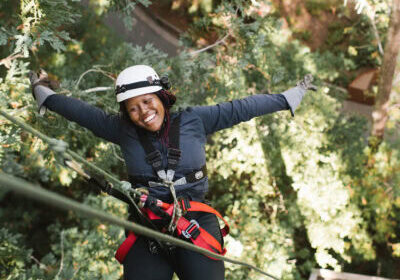person zip lining in the redwoods