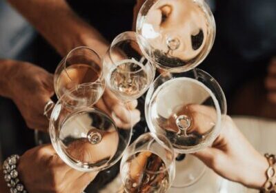 Looking down on wine glasses doing a toast